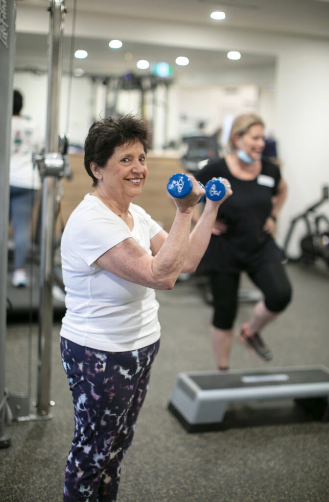 Cancer - lady in the gym with weights