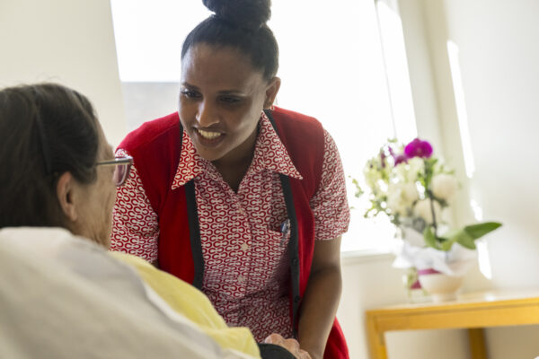 Cabrini nurse assisting a patient